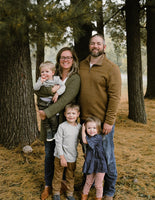 Nick Shope with family standing in forest smiling