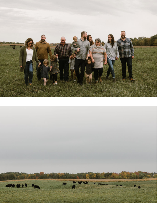 peterson family in cow field smiling with cows and trees